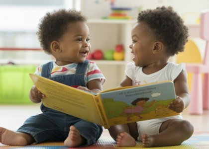 Toddlers sharing a book